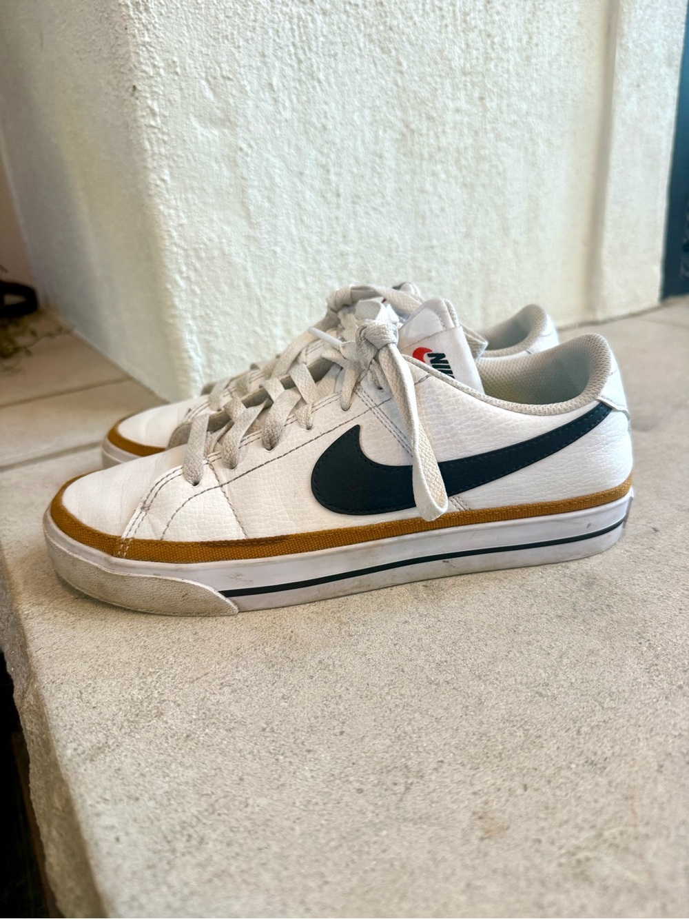 Nike White Low-Top Sneakers with Black Swoosh and Brown Trim